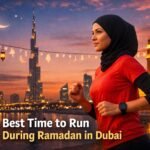 Female runner jogging at sunset in Dubai during Ramadan with skyline and mosque lights
