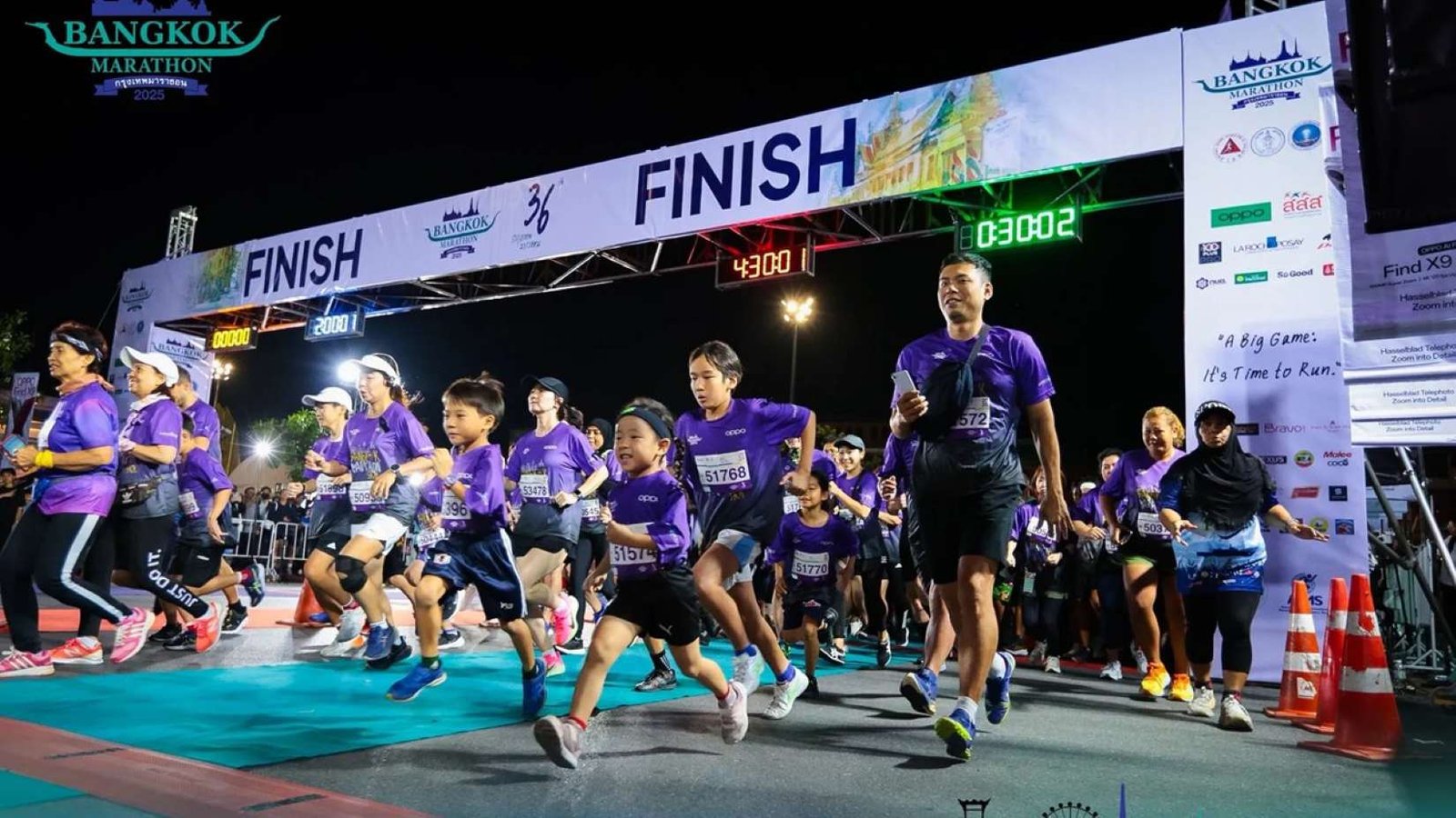 Runners at the Bangkok Marathon passing the Royal Grand Palace at midnight, Bangkok, Thailand