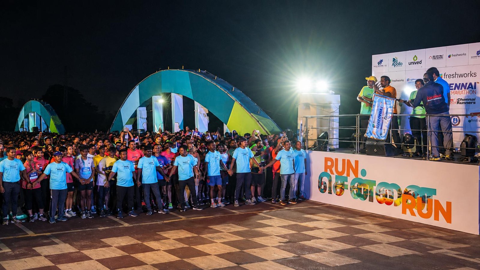 Runners gather at the start line of the Freshworks Chennai Marathon at Island Grounds before the early morning race begins in Chennai.