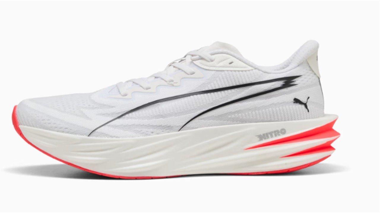 Side profile of the Puma Deviate Pure Nitro men's road running shoe in white with Nitro foam midsole and performance racing design.