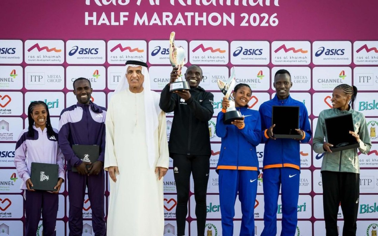 Winners of the Ras Al Khaimah Half Marathon 2026 on the podium with their trophies, presented by RAK Tourism Development Authority officials