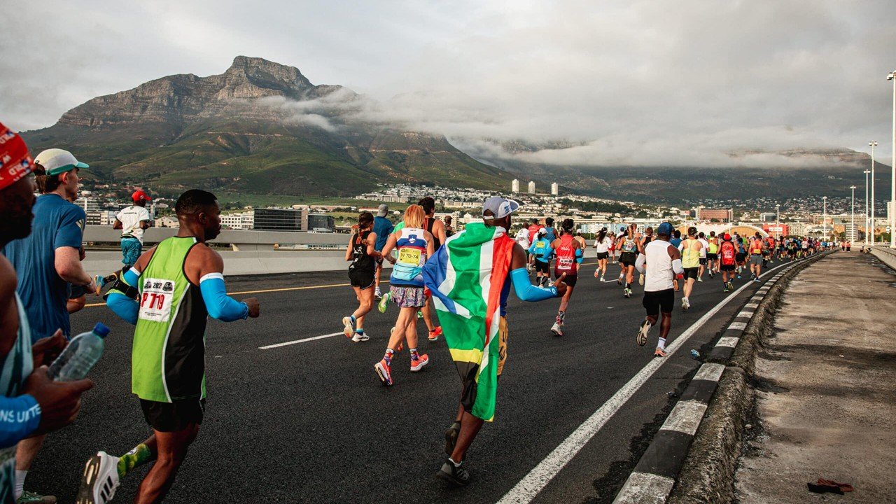 Runners at the 2026 Sanlam Cape Town Marathon with Table Mountain in the background — Africa's first Abbott World Marathon Major