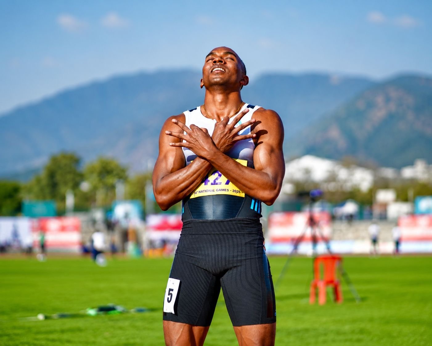 Animesh Kujur celebrates after his sprint event at the 38th National Games 2025, wearing bib number 427