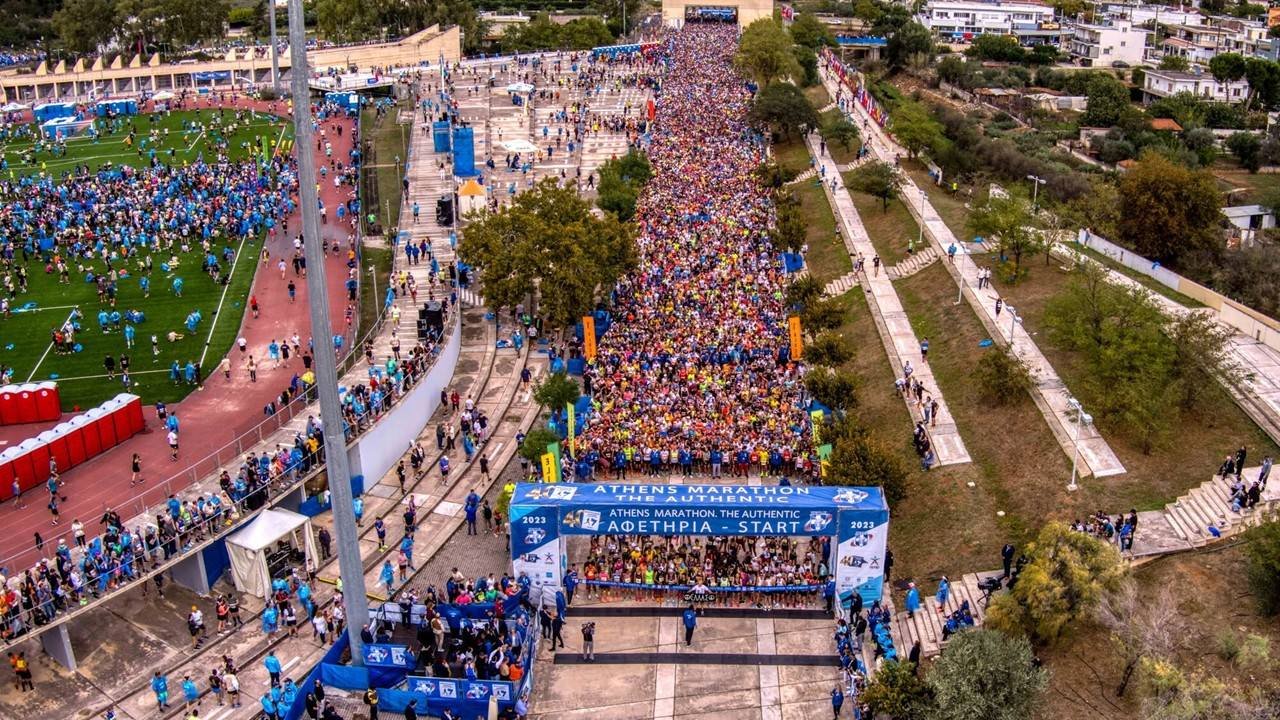 Aerial view of thousands of runners at the start line of the Athens Marathon The Authentic in Marathon town, Greece