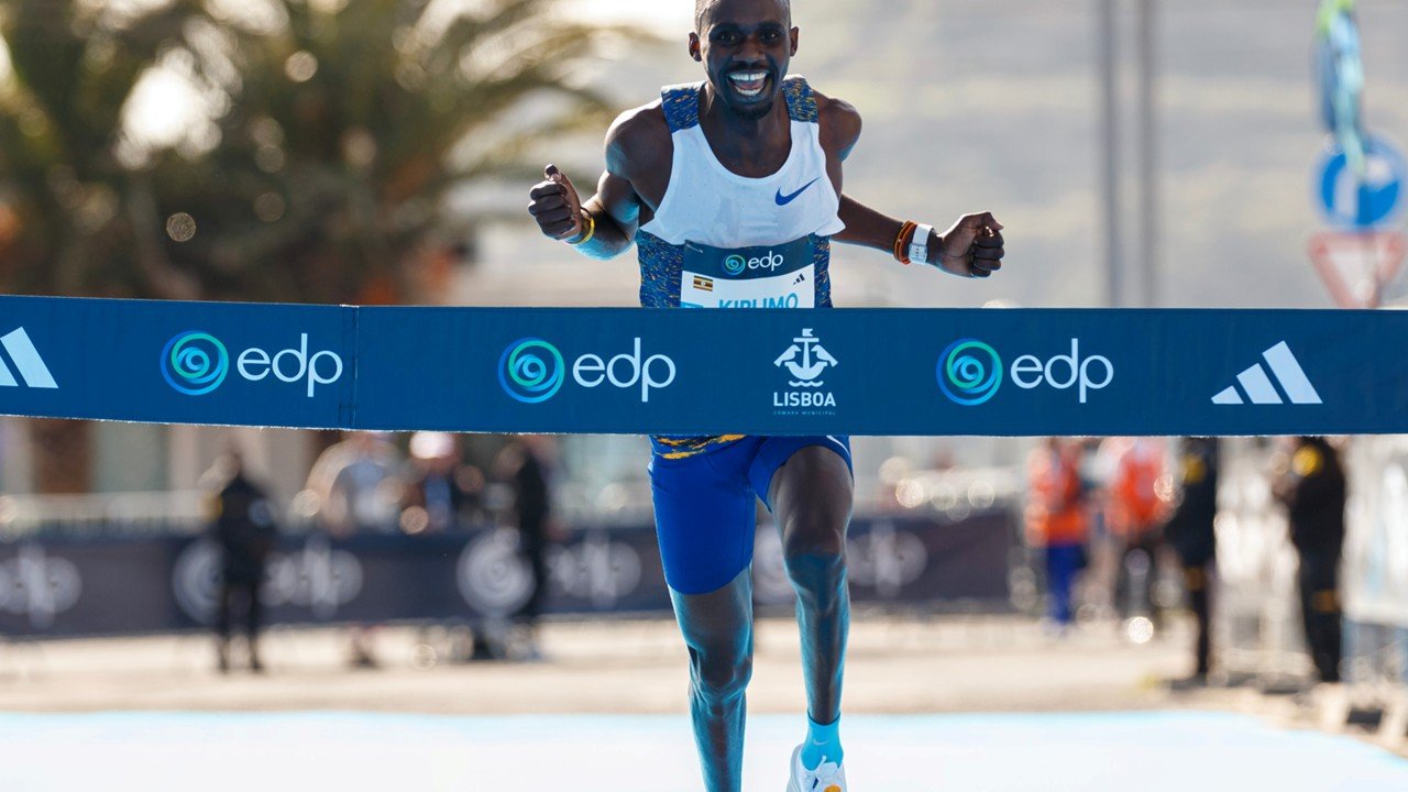 Runner crossing marathon finish line triumphantly