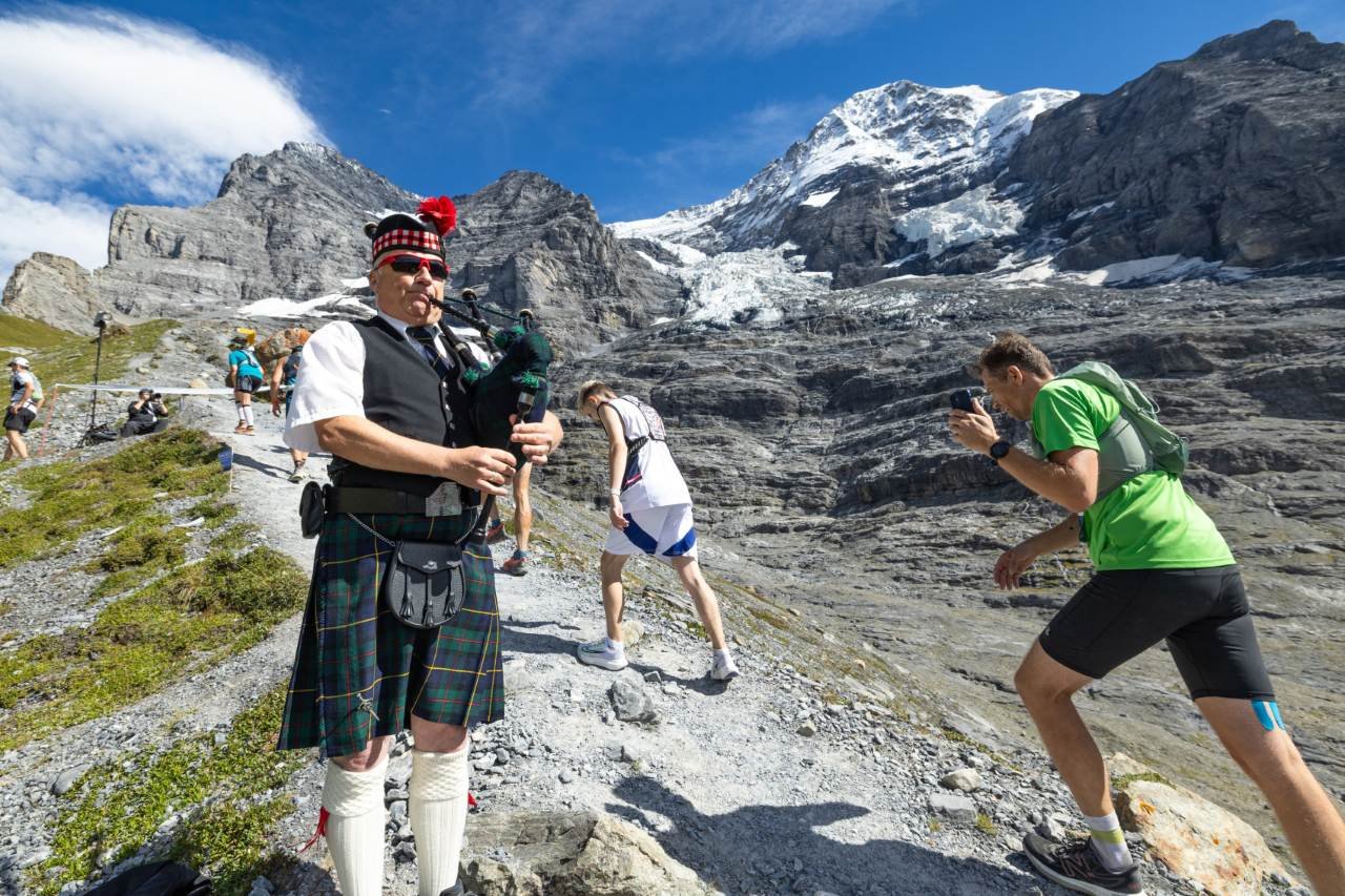 Runners climbing the Jungfrau Marathon course through the Swiss Alps toward Eigergletscher