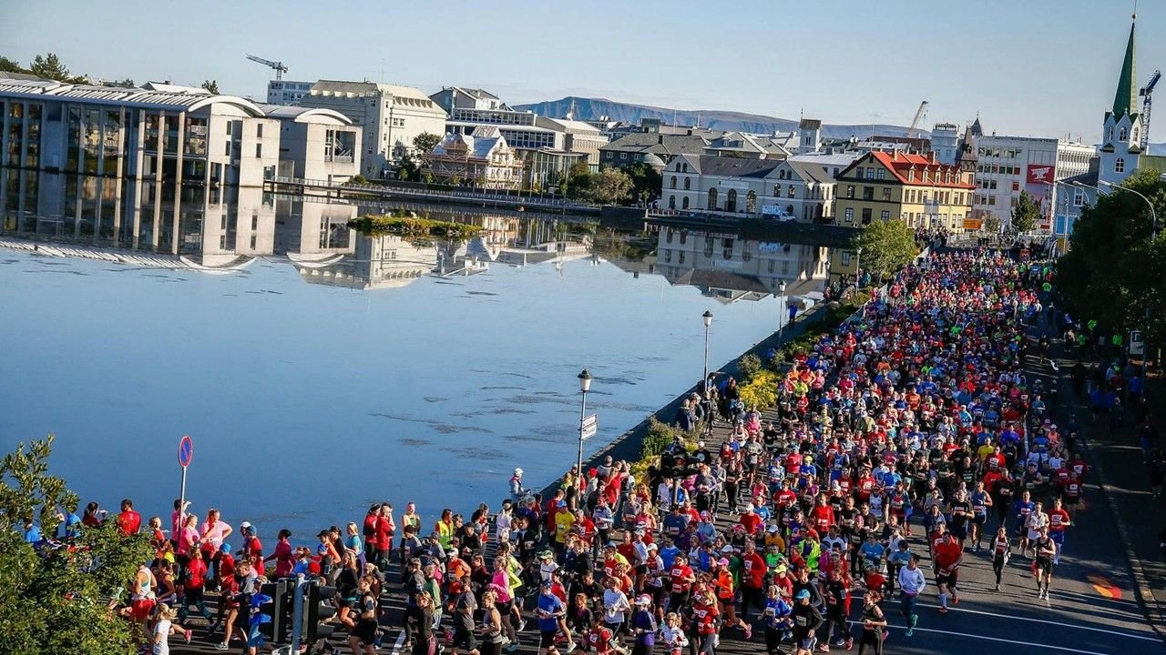 Runners at the Islandsbanki Reykjavik Marathon 2026 along the coastal promenade with views of the North Atlantic
