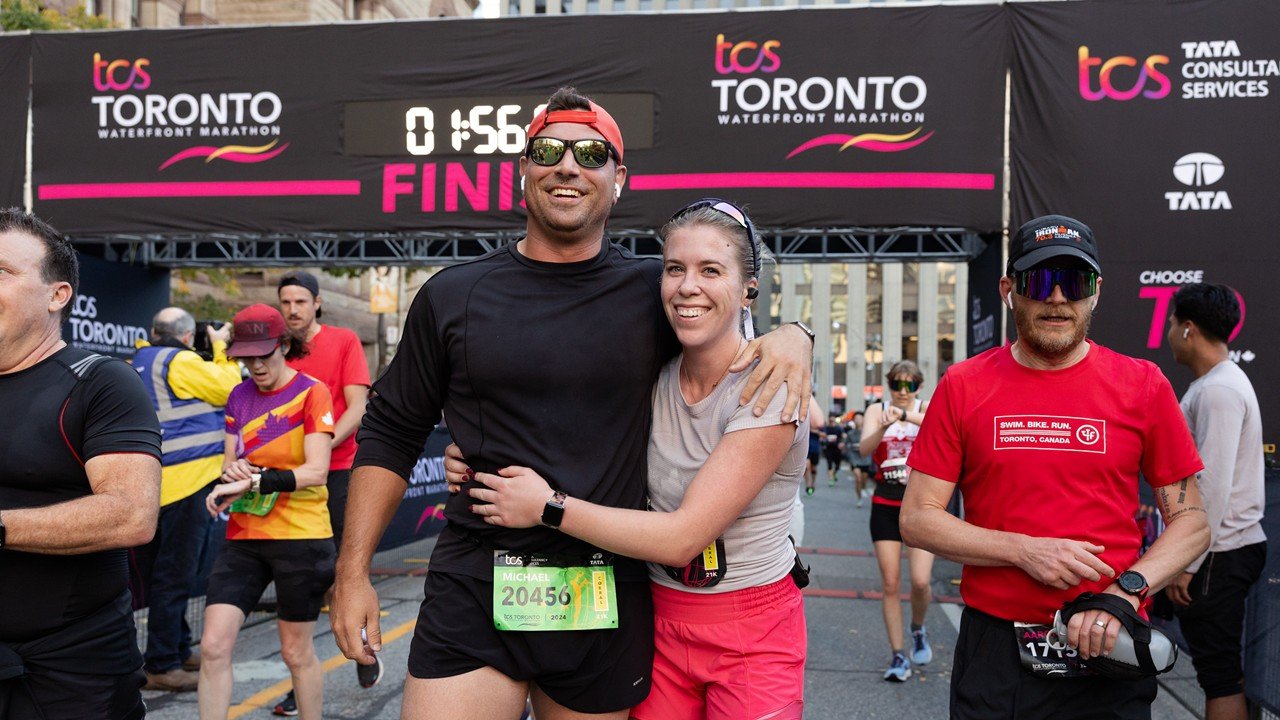 TCS Toronto Waterfront Marathon 2026: The Complete Race Guide 2 Runners racing at the TCS Toronto Waterfront Marathon along the Lake Ontario waterfront
