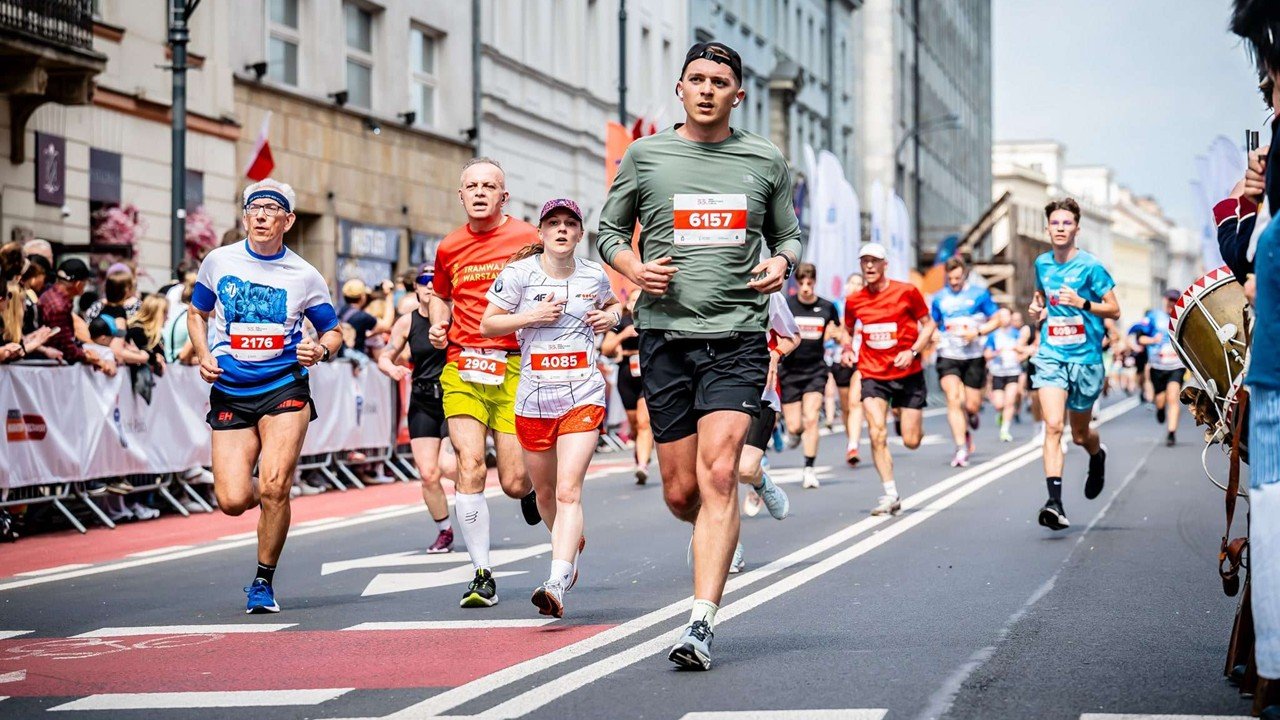 Runners racing through the streets of Warsaw at the 2026 Warsaw Marathon