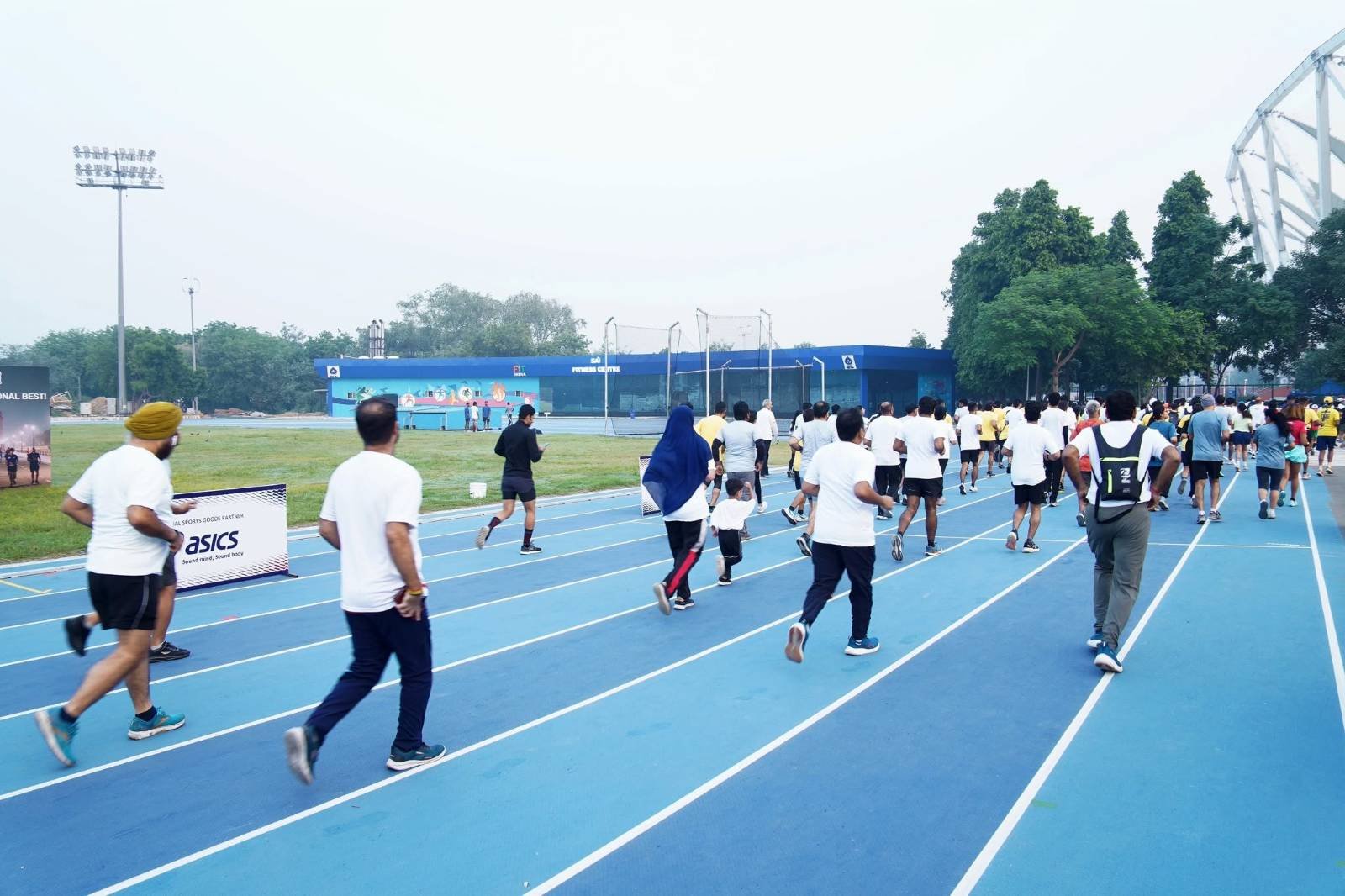 Runners crossing the start line at the Cognizant Delhi Marathon at Jawaharlal Nehru Stadium