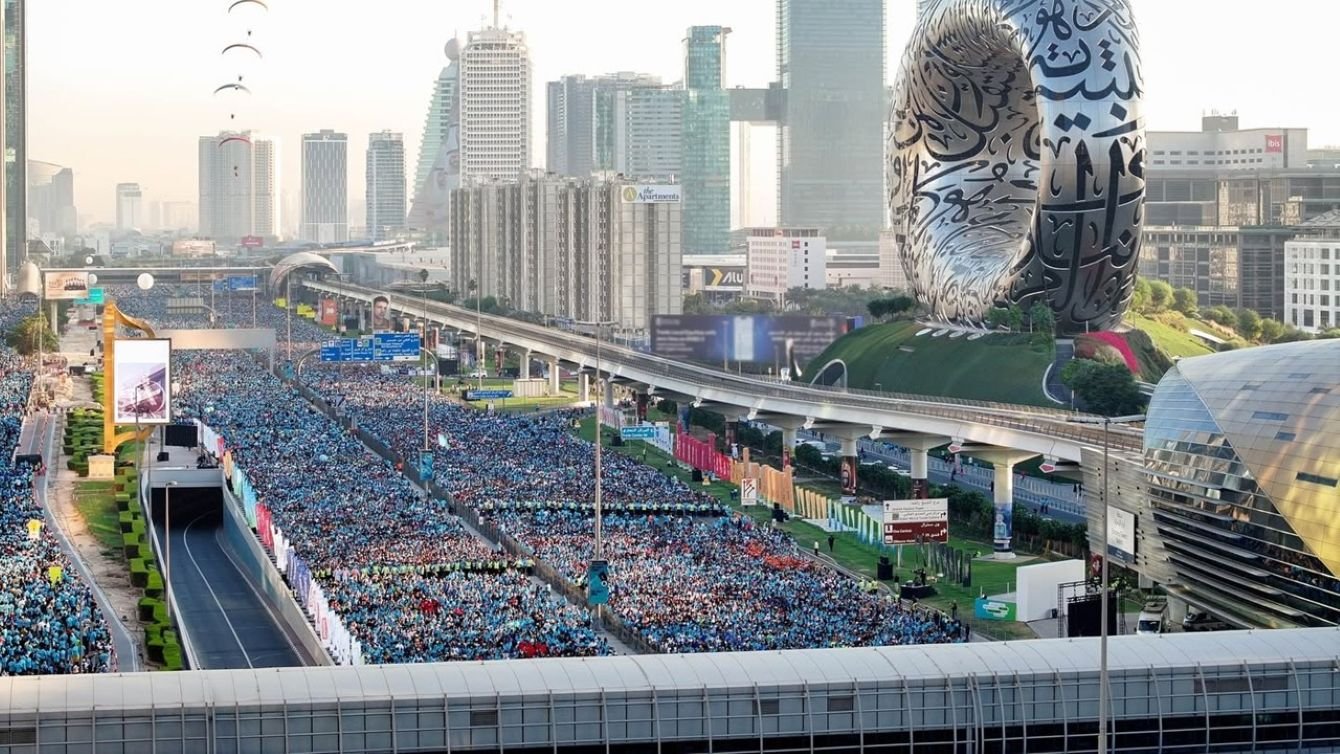 Aerial view of Dubai Run with thousands of runners filling Sheikh Zayed Road, Museum of the Future visible in the background, Dubai skyline