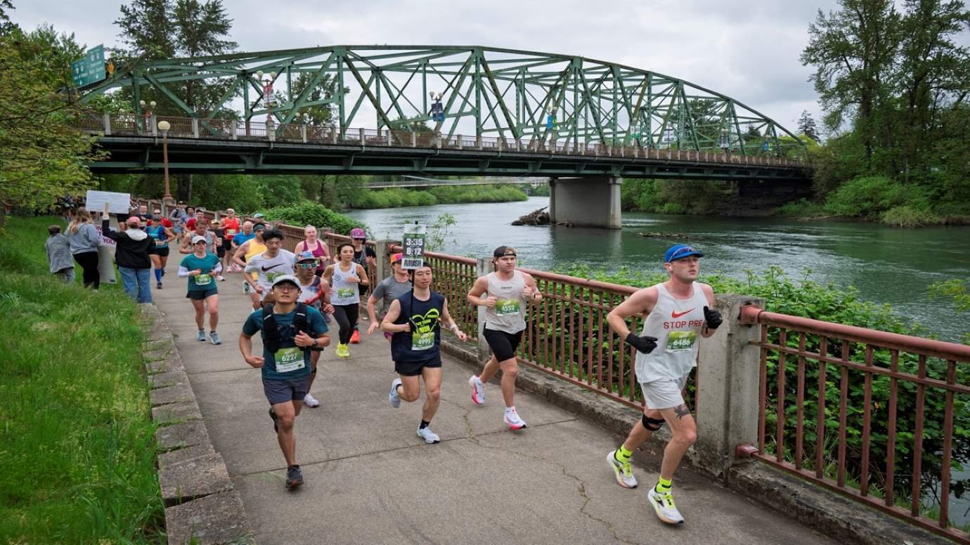 Runners racing along the Willamette River path at the Eugene Marathon in Eugene Oregon