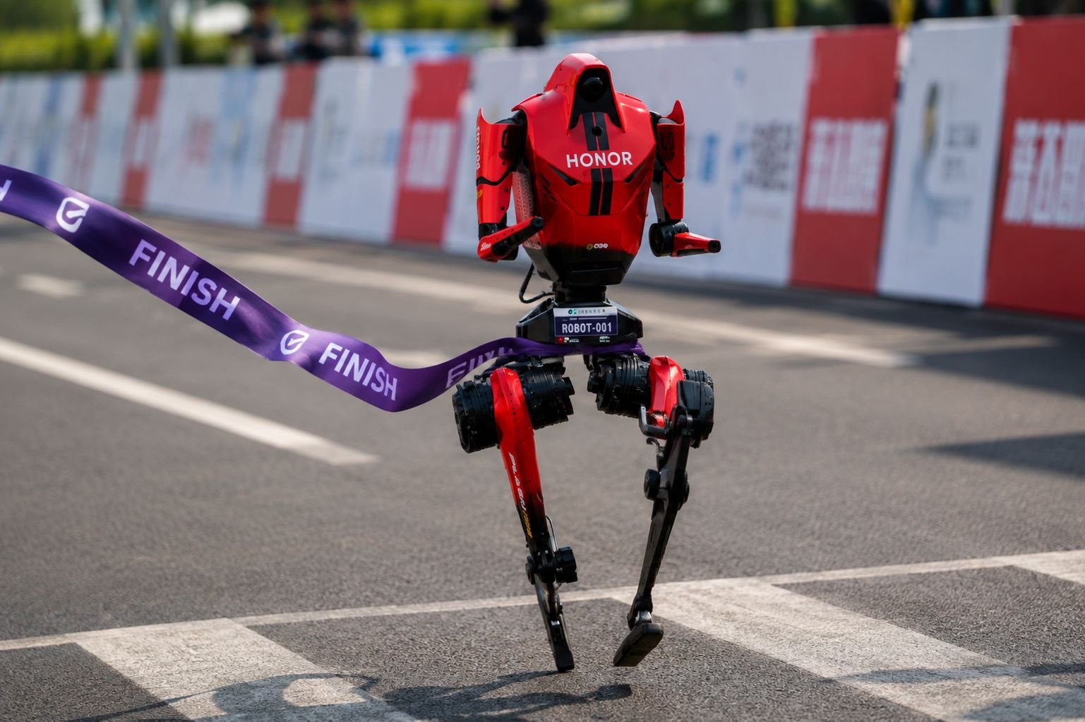 Honor Lightning humanoid robot (ROBOT-001) crossing the finish line at a race in Beijing, China