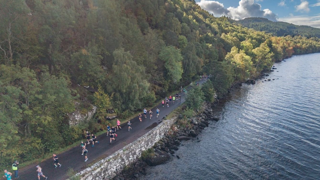 Runners on the B852 road along the south-east shore of Loch Ness during the Baxters Loch Ness Marathon
