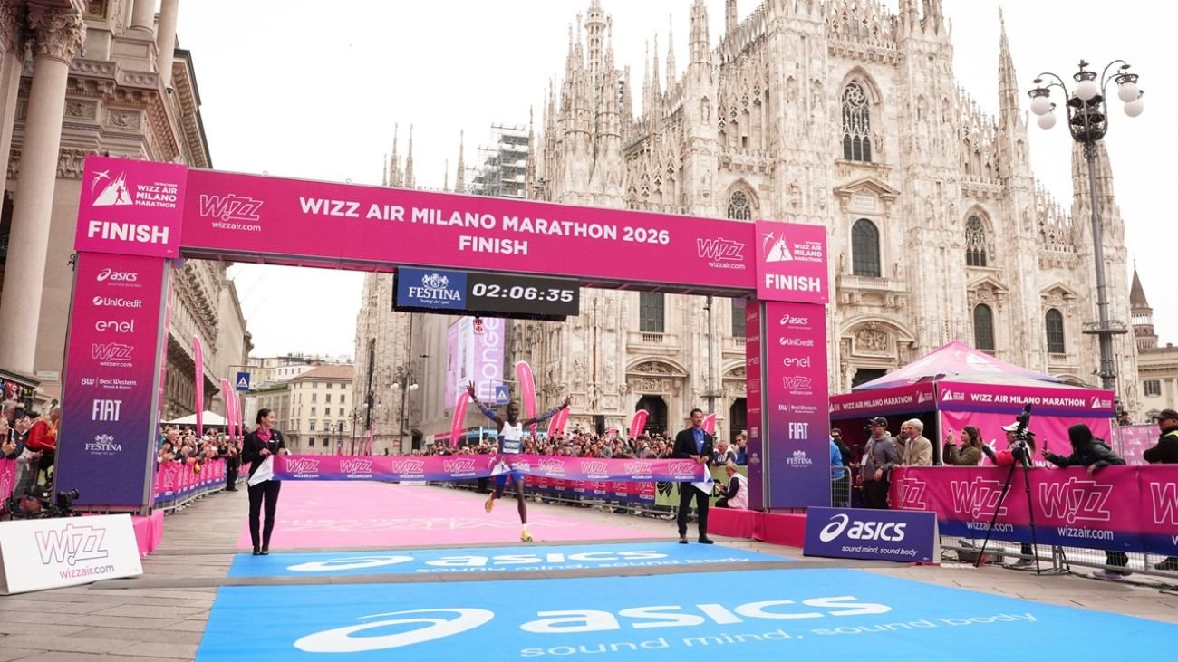 Runners crossing the finish line at the Wizz Air Milano Marathon with the Duomo cathedral in the background, Piazza del Duomo, Milan