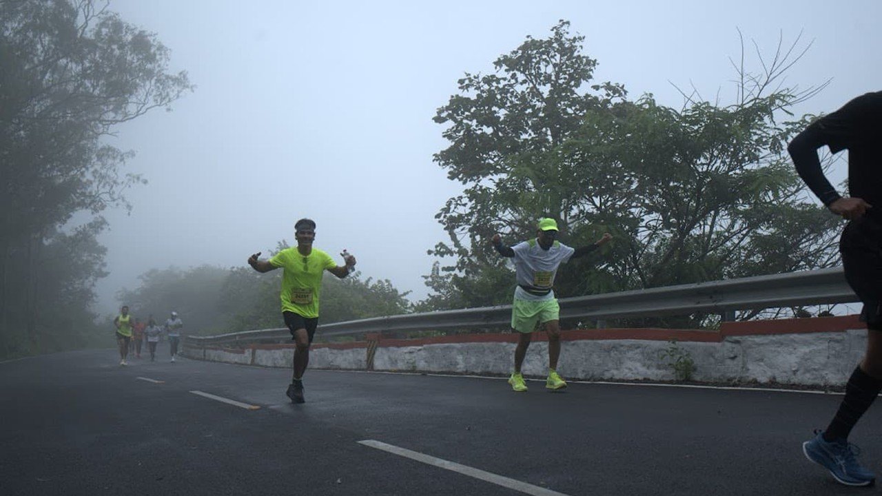 Runners making the 530m climb through monsoon mist at DivyaSree Nandi Monsoon Run 2026