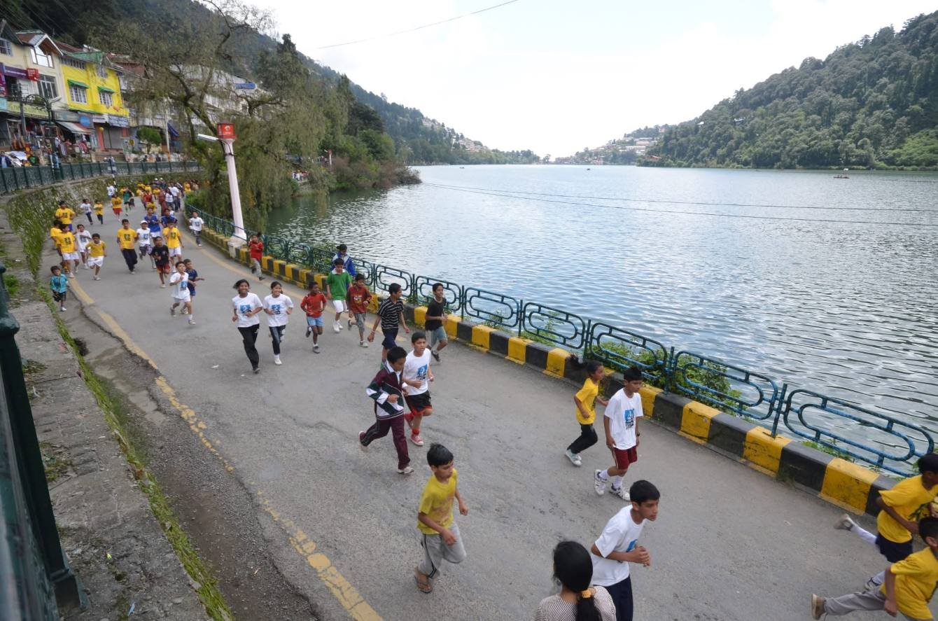 Runners tackling the steep hill climb during the Nainital Monsoon Mountain Marathon through mist-laden pine forests