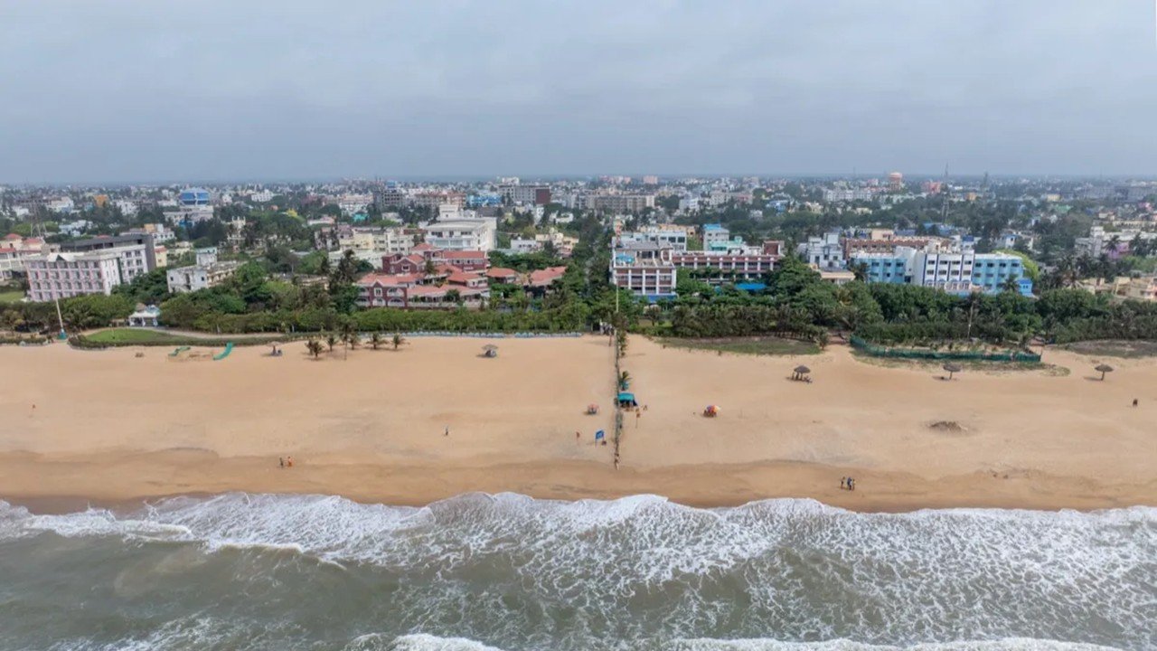 Runners on the golden sands of Puri Beach at the OMC Puri Coastal Marathon 2026, Bay of Bengal, Odisha
