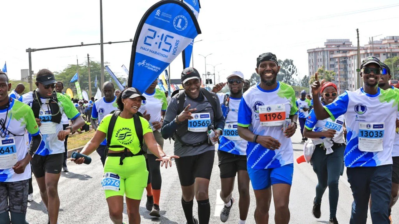 Standard Chartered Nairobi Marathon 2026: Complete Guide, Course & Tips 2 Runners at the Standard Chartered Nairobi Marathon 2026 on the Southern Bypass with Nairobi National Park in the background