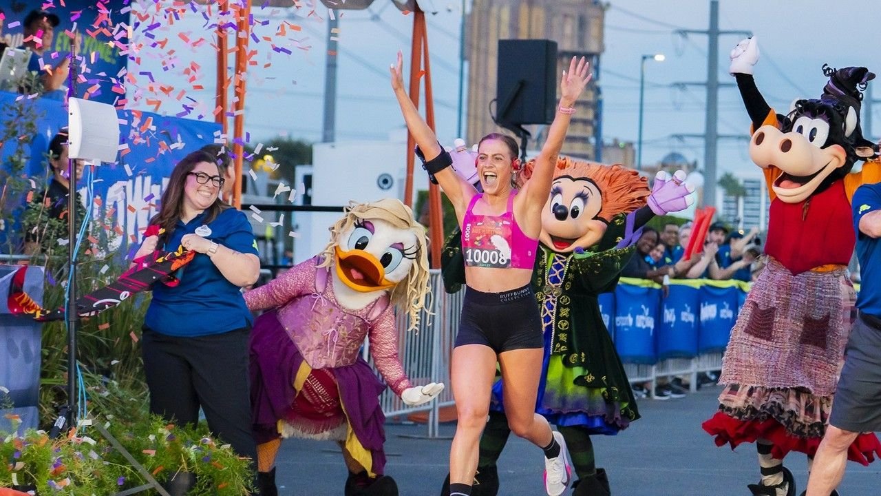 Runners in costume racing past Cinderella Castle at the Walt Disney World Marathon Weekend in Orlando Florida