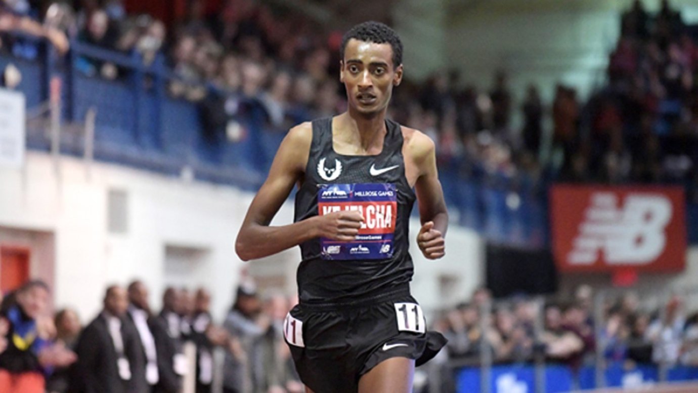 Yomif Kejelcha running at an indoor track meet in Boston where he set the mile world record of 3:47.01