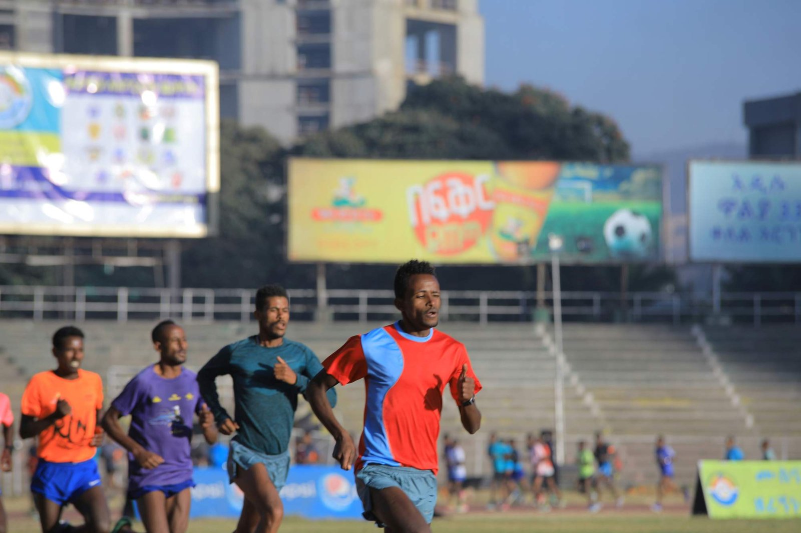 Group of Ethiopian runners training together at a stadium in Addis Ababa