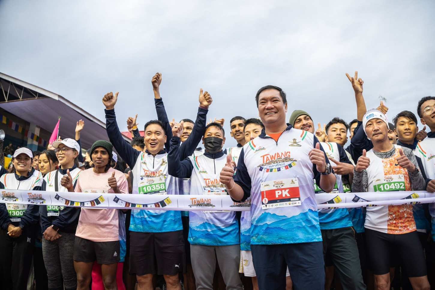 Arunachal Pradesh Chief Minister Pema Khandu at the Tawang Marathon start line with participants wearing the official race jersey