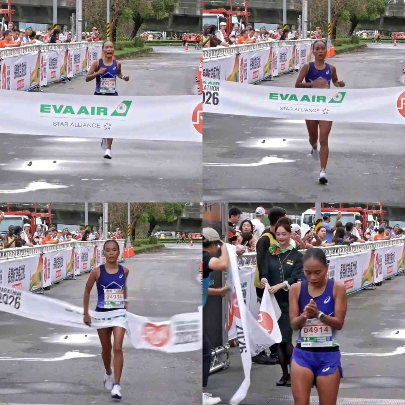 Runner crossing finish line, celebrating victory.