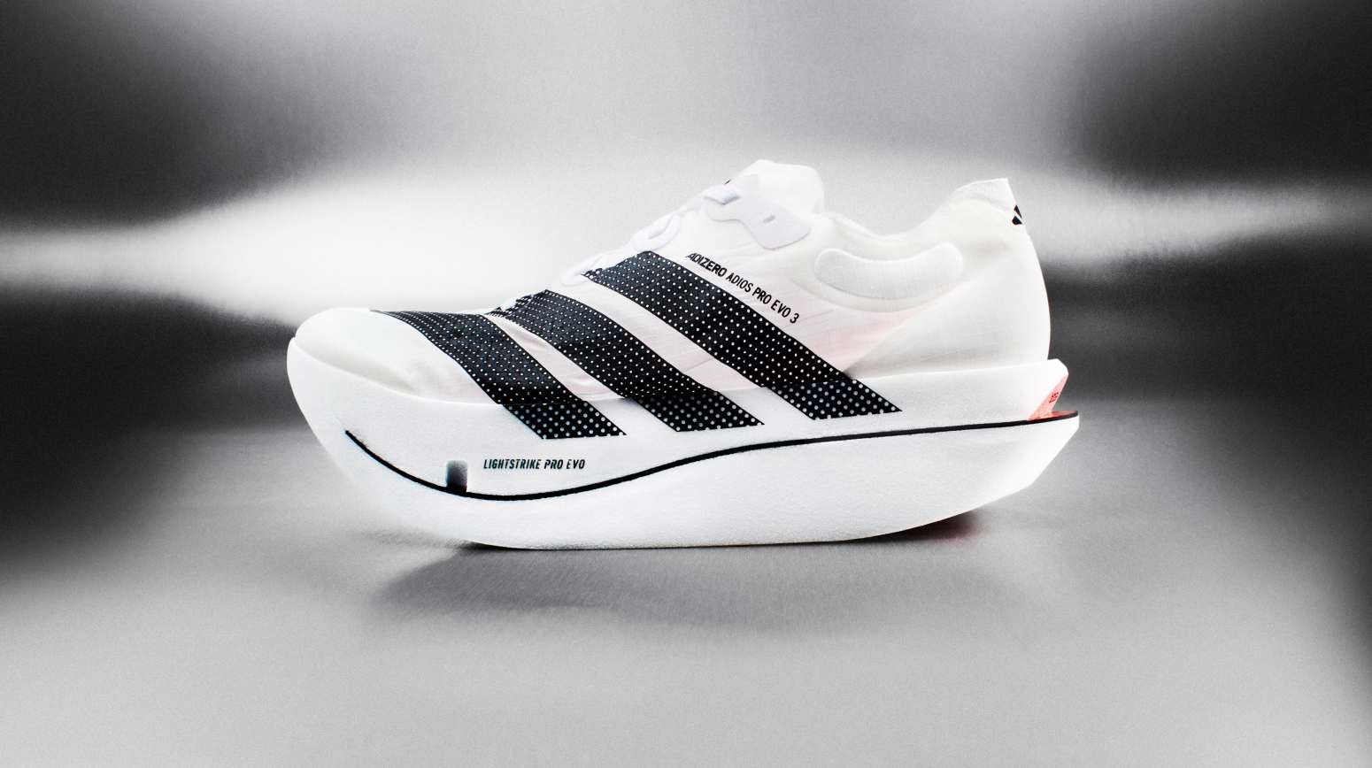 Adidas Adizero Adios Pro Evo 3 marathon racing shoe in white with black three stripes and Lightstrike Pro Evo midsole