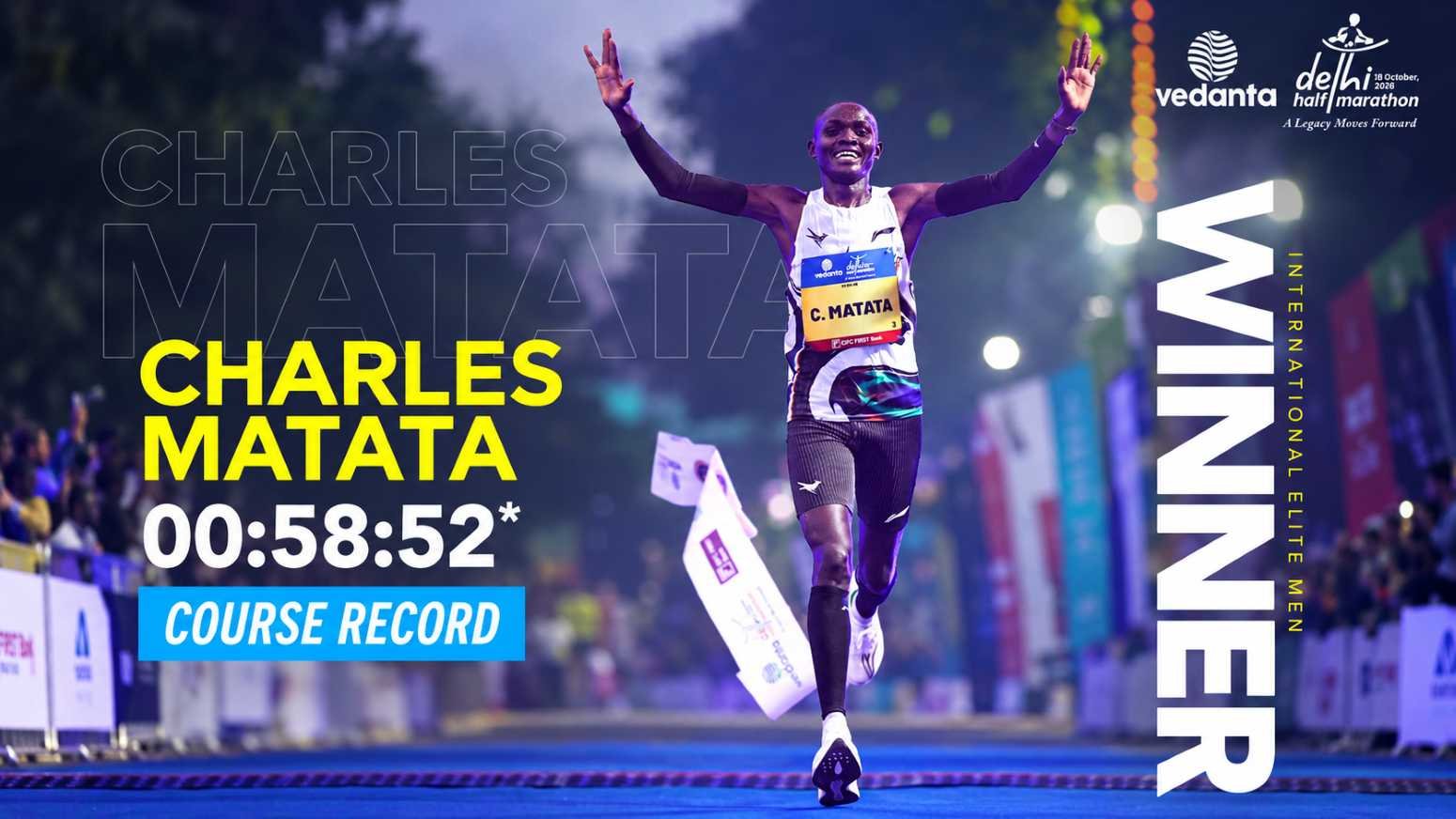 Charles Matata crosses the finish line with arms raised at the Vedanta Delhi Half Marathon 2026, clocking a course record 00:58:52 to win the International Elite Men's title