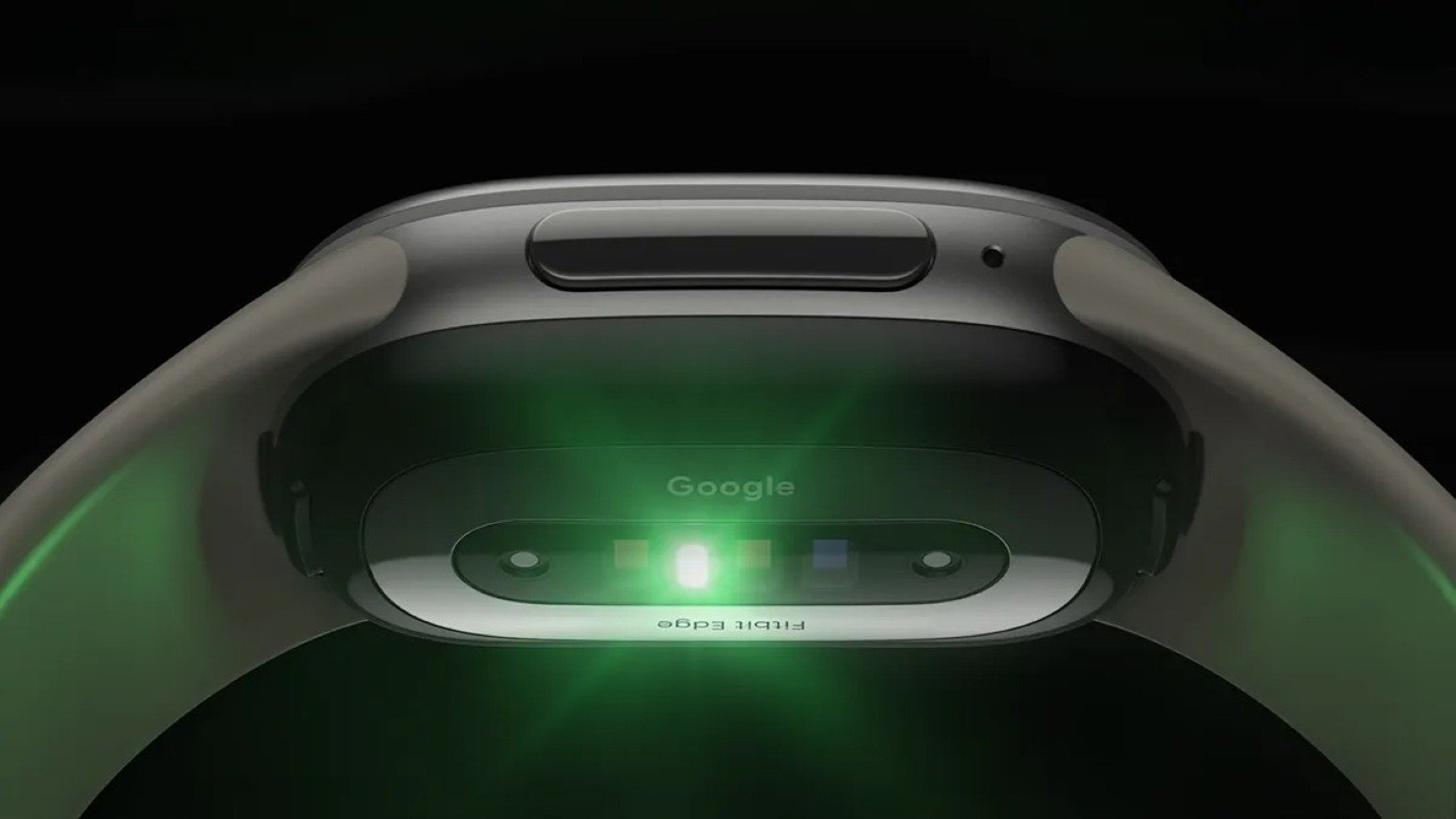 Close-up of the Google Fitbit Edge rear sensor array showing green optical heart rate and health monitoring sensors