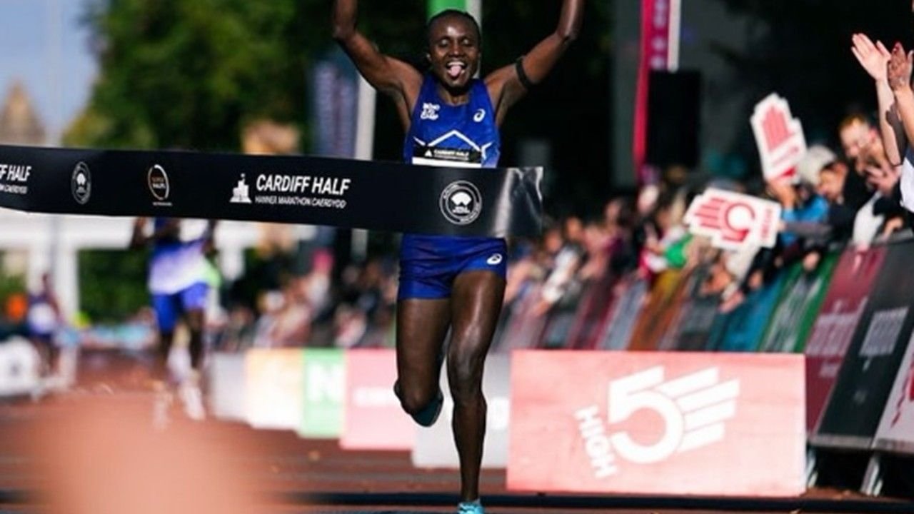 Joyciline Jepkosgei breaking the tape at the 2026 Cardiff Half Marathon to set a new women's course record of 1:05:39