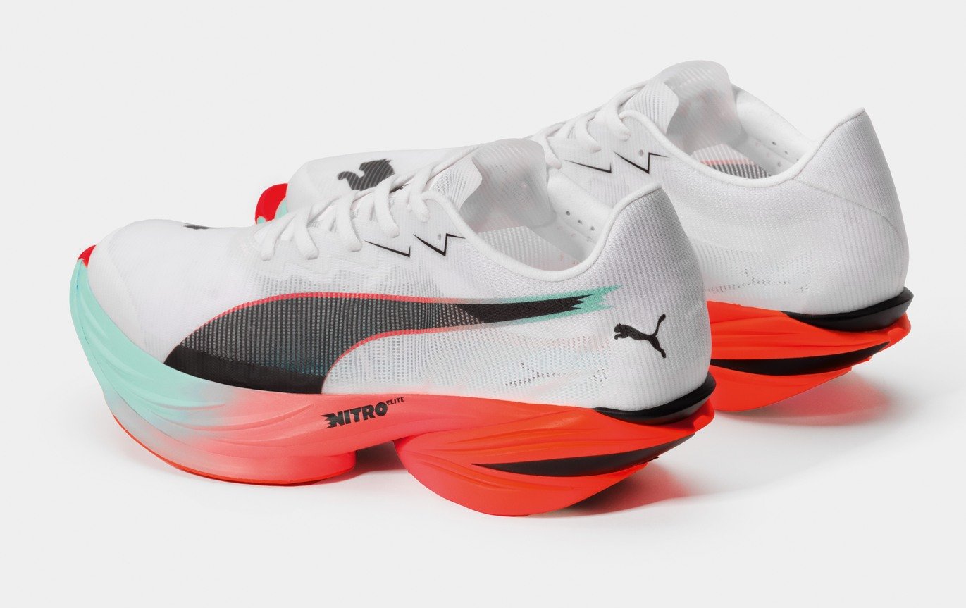 Puma Fast-R Nitro Elite 3 running shoes in white and glowing red, rear three-quarter view showing the NITRO Elite split midsole and extended carbon PWRPLATE