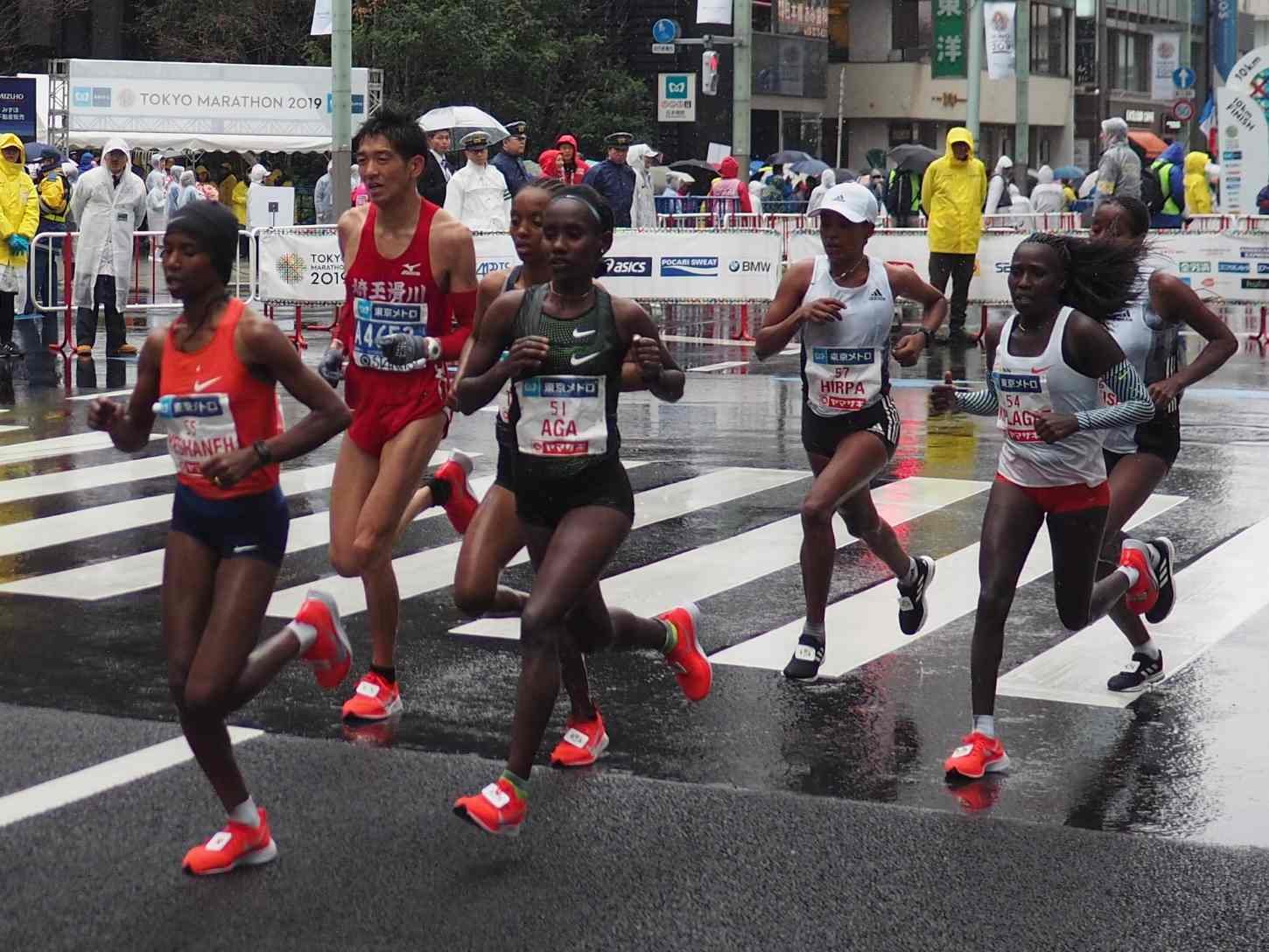 Ruti Aga (bib 51) running through rain-soaked streets at the 2019 Tokyo Marathon, which she won in 2:20:40