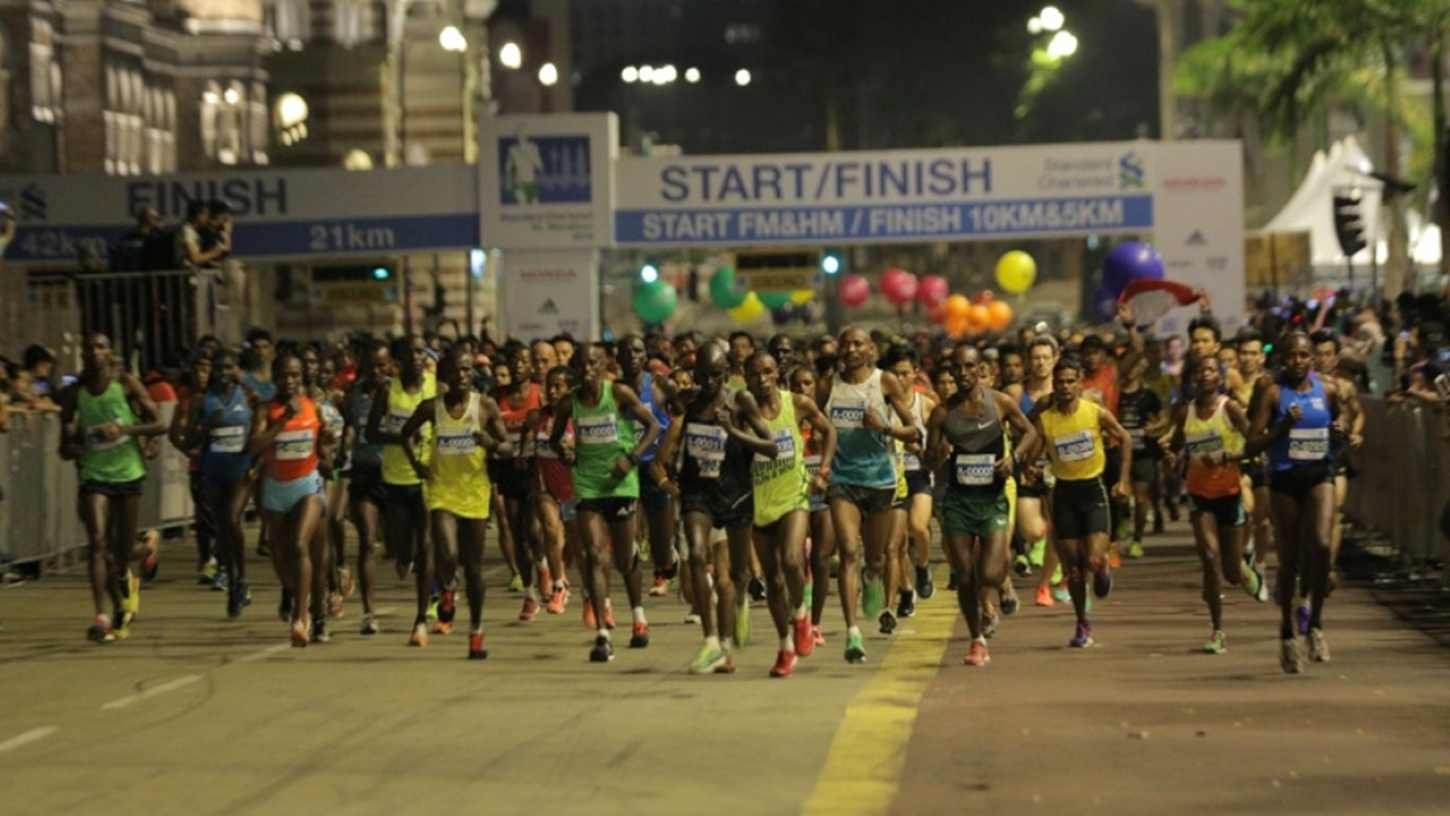Elite runners surge from the Dataran Merdeka start line at the Standard Chartered KL Marathon 2026 full marathon flag-off under floodlights at 3:30am
